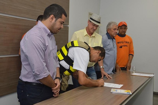Luiz Carlos e mototaxistas no ato de assinatura de decreto