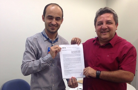 Jair Farias (direita) e o superintendente da CEF do Tocantins, exibem convênio assinado